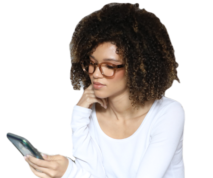A woman sitting looking at her smart phone