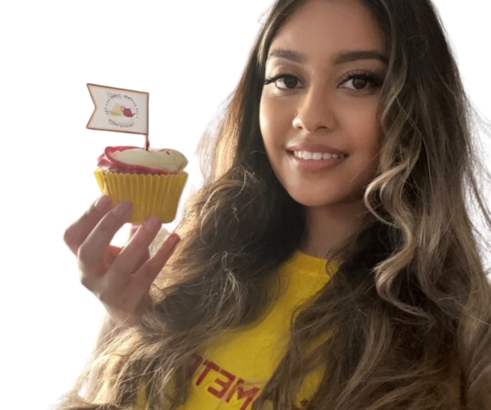A woman holding a cupcake