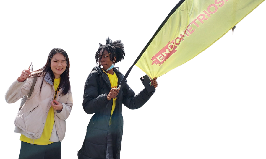 Two woman cheering runners at an event