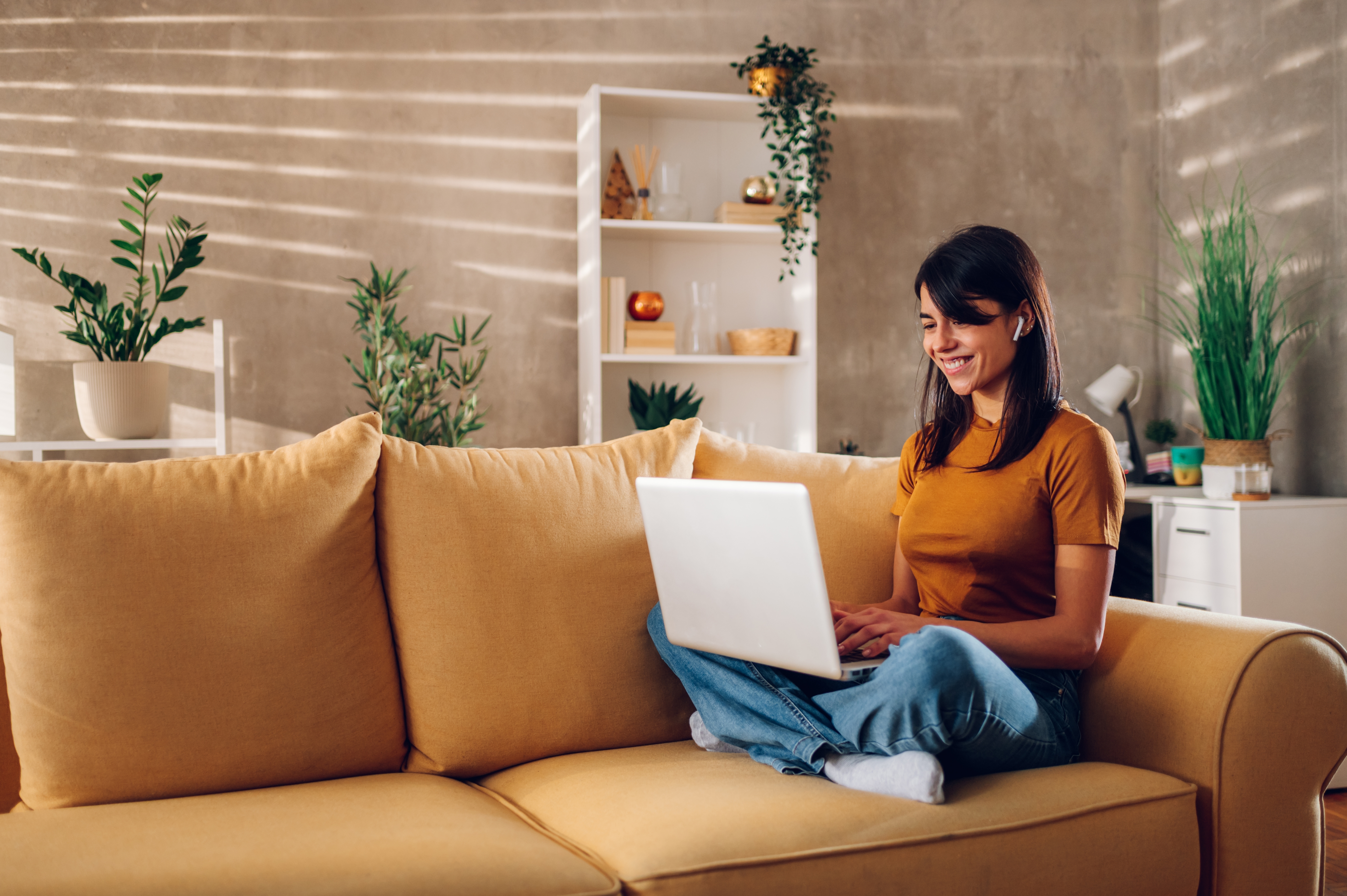 Woman sitting on couch with laptop