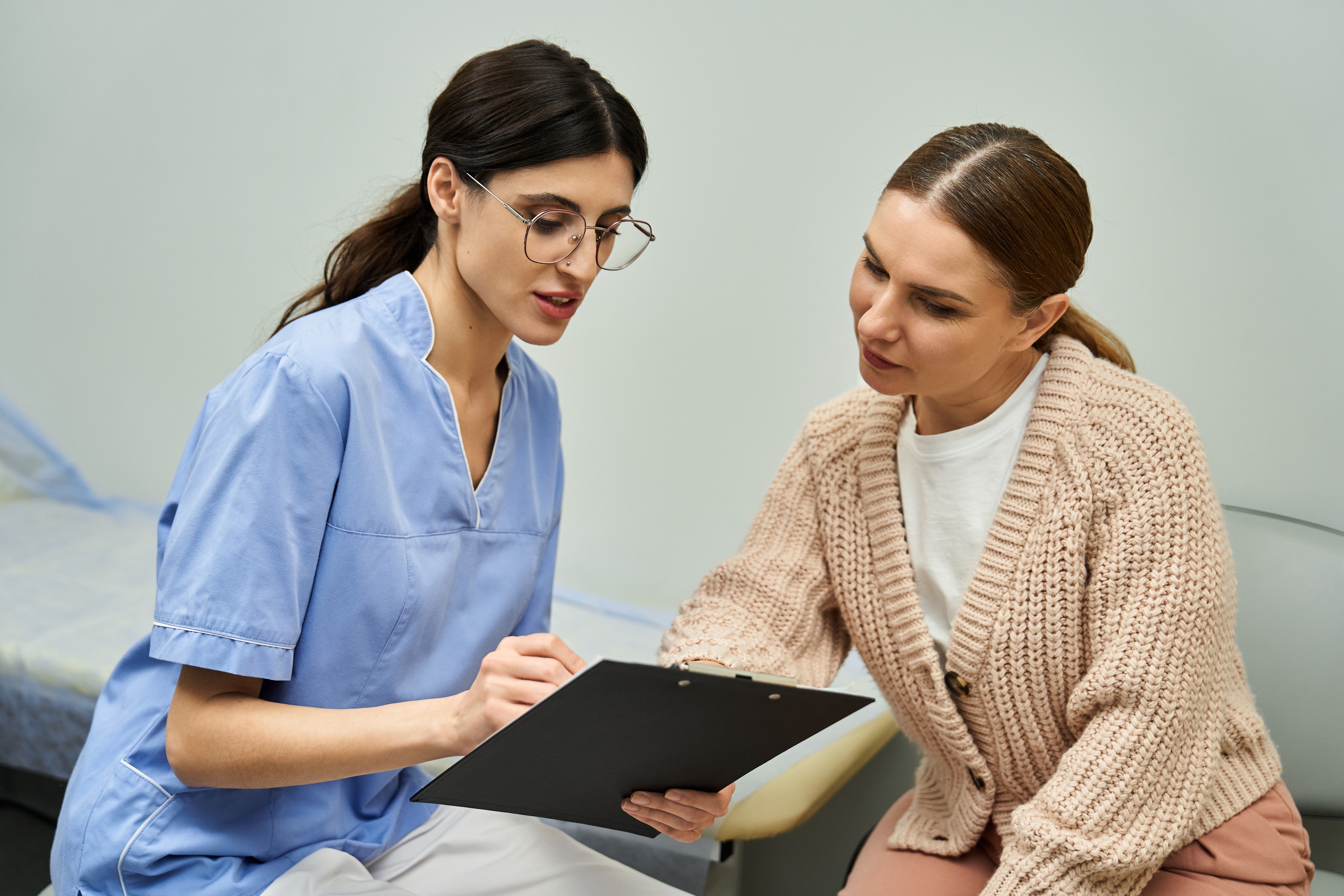 Woman discussing care with doctor