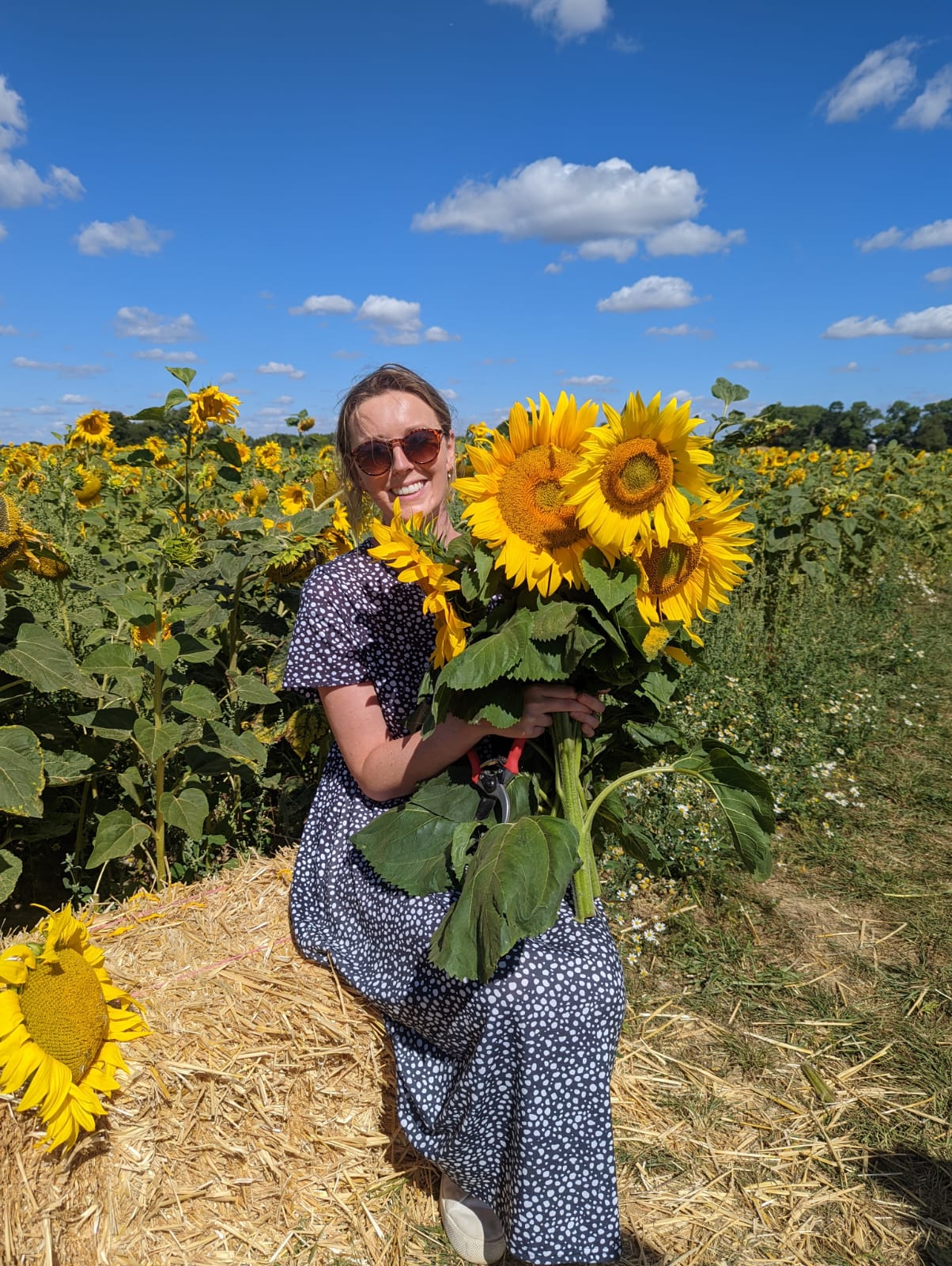Woman smiling with sunflowers