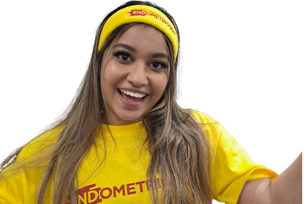 Woman wearing Endometriosis UK T-shirt and headband