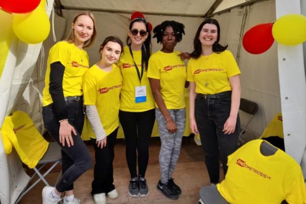 A group of people in yellow Endometriosis UK t-shirts