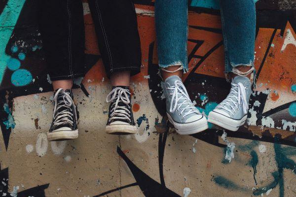 Teenagers wearing jeans and trainers