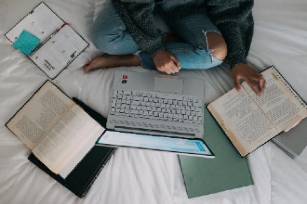 woman with laptop and books