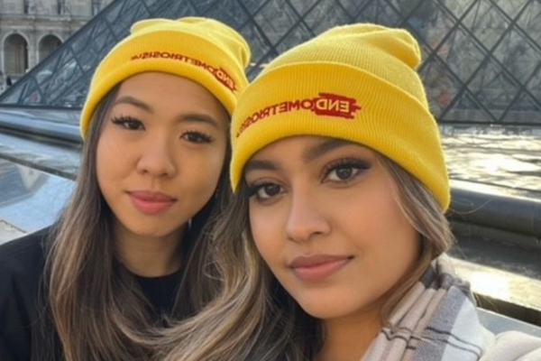 Two women wearing Endometriosis UK beanie hats