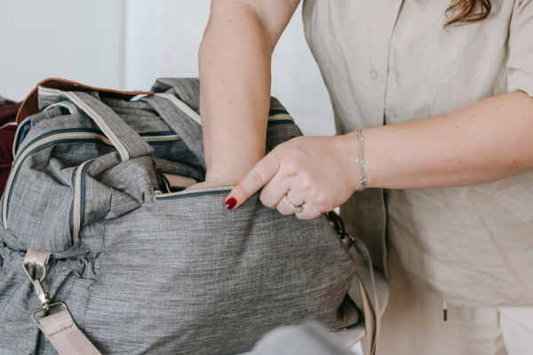 A photo of a woman packing a bag