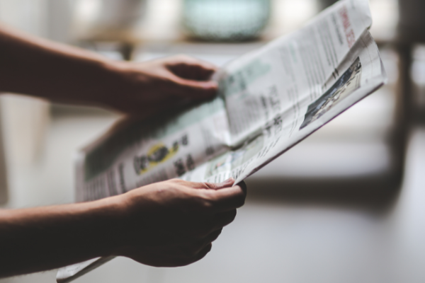 Person holding newspaper
