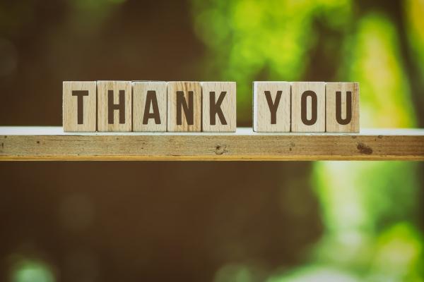 Wooden planks spelling out the words Thank You on a shelf