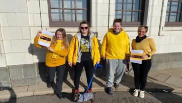 Volunteers in a yellow outfits.