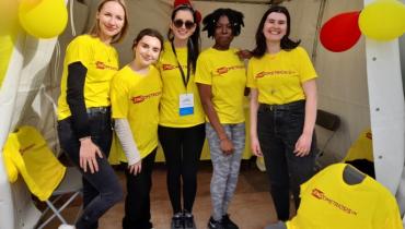 A group of people in yellow Endometriosis UK t-shirts