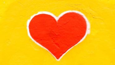 A red heart on a yellow background