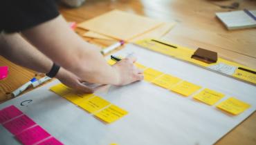 Yellow and pink post it notes on a white background