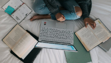 woman with laptop and books