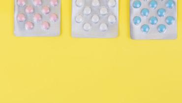 Pills in packets on a yellow background