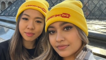 Two women wearing Endometriosis UK beanie hats