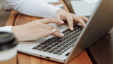 A person typing on a laptop