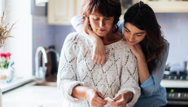 Two women hug