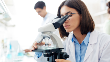 A photo of a researcher looking into a microscope